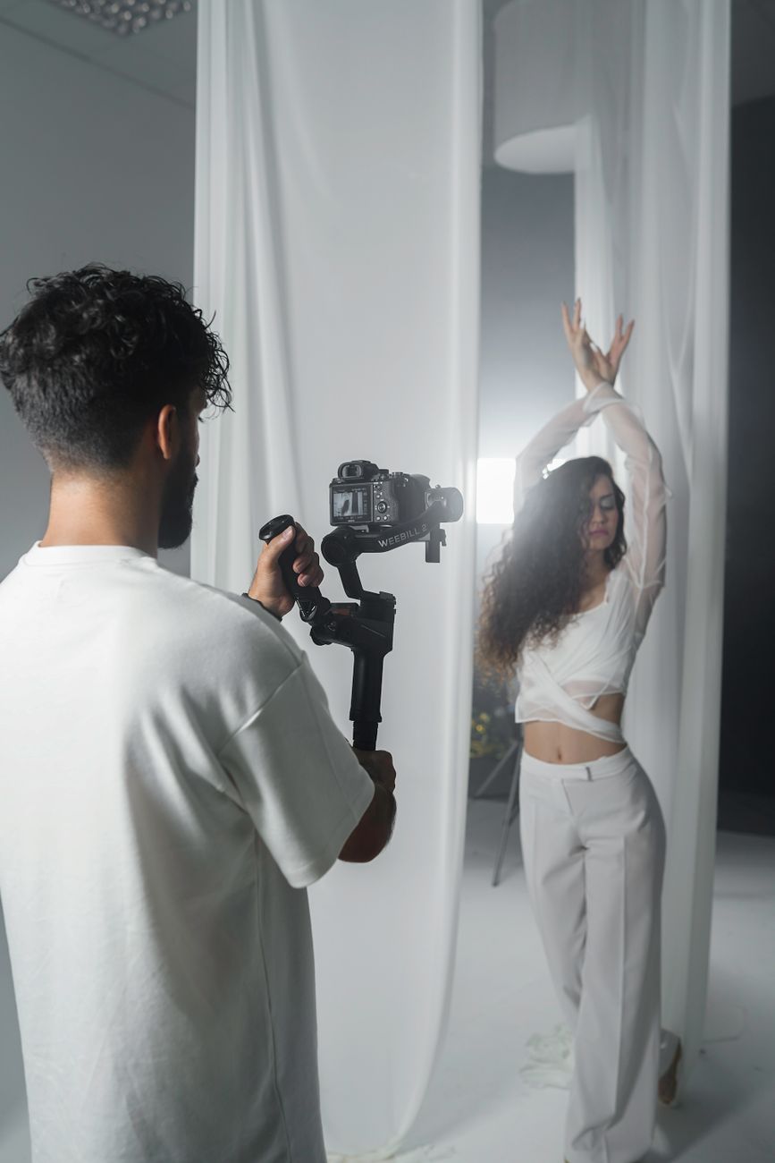 a woman is taking a video with a camera