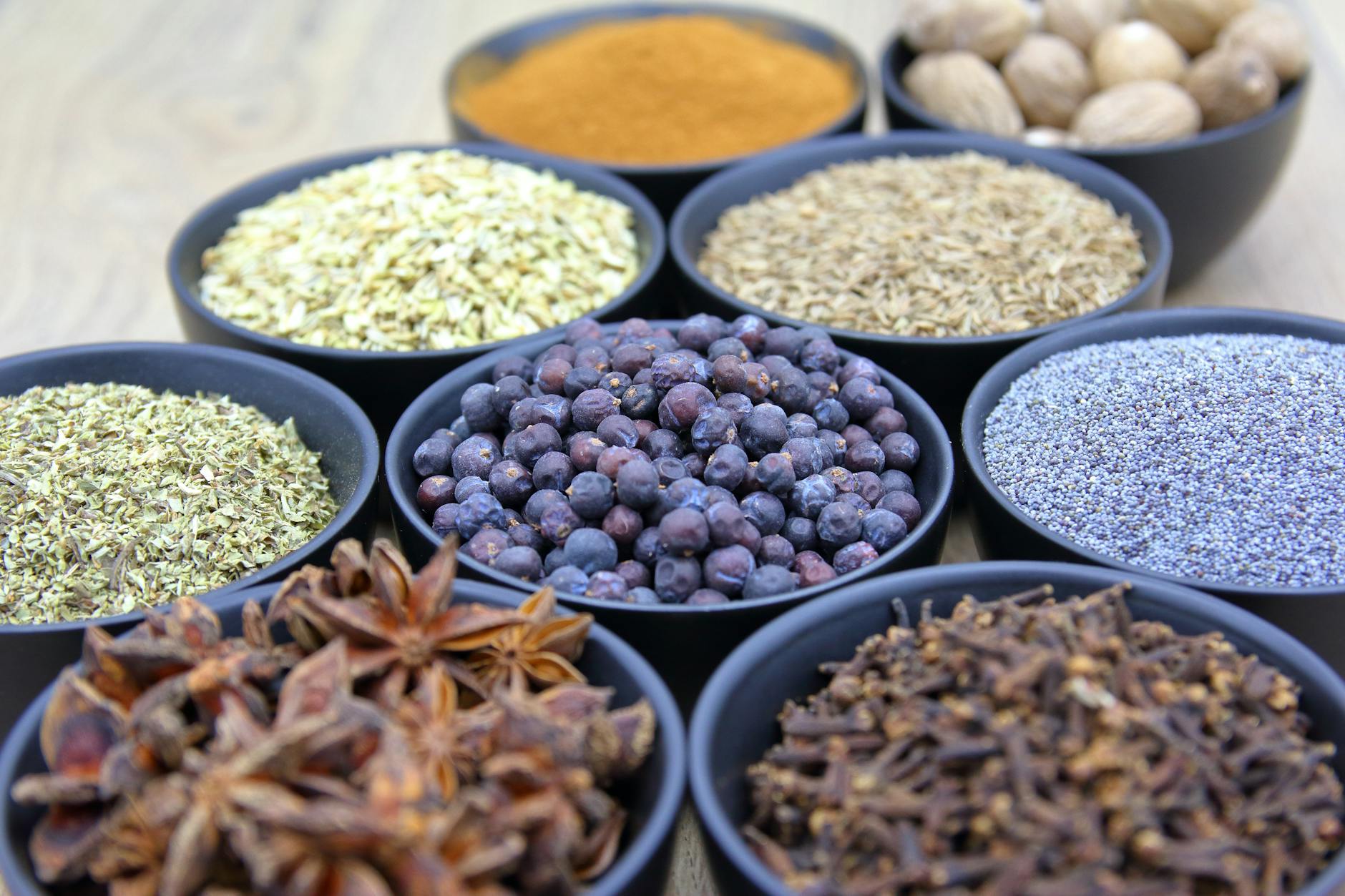 assorted spices in black bowls flat lay