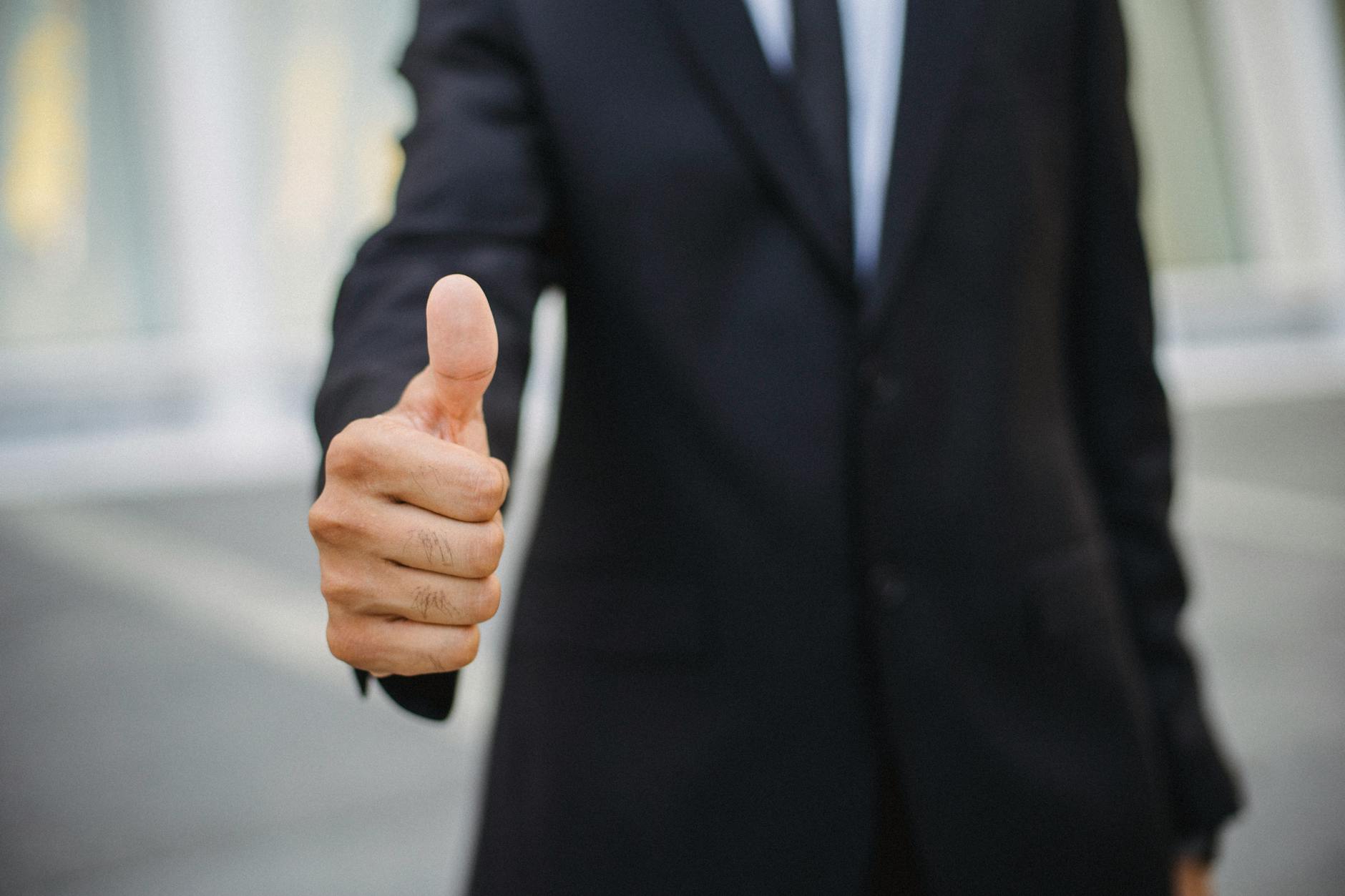 a close up shot of a person doing a thumbs up
